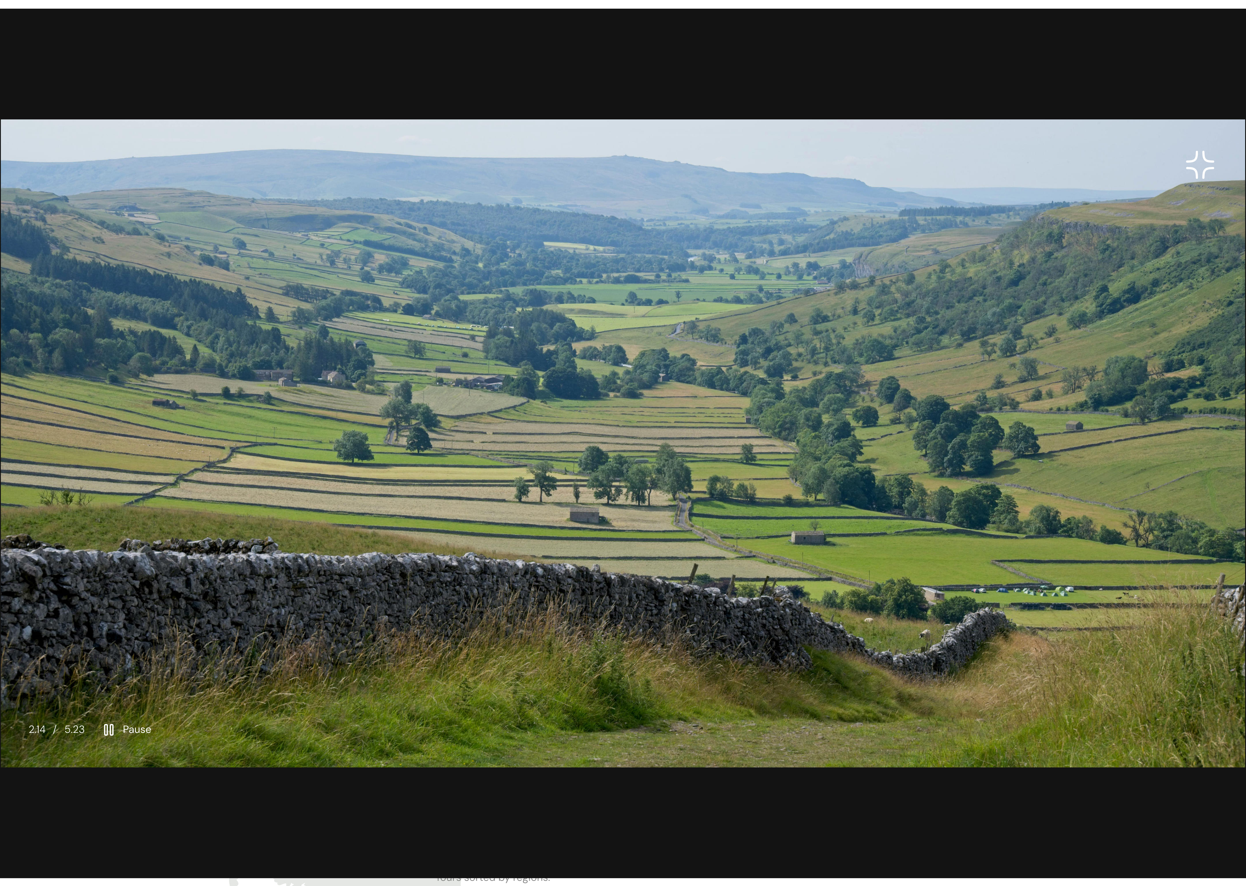 Homepage of a tour service site featuring hiking trails in England - video presentation section. The video is being played, the player view is expanded to cover up most of the screen.